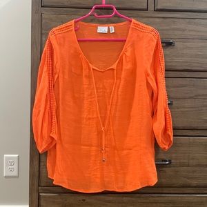 Kim Rogers orange top